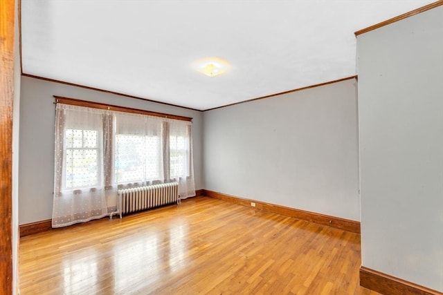 17 Matchett St, Boston, MA 02135 - empty room featuring radiator heating unit, crown molding, wood finished floors, and baseboards