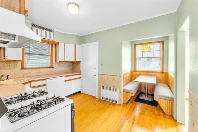 17 Matchett St, Boston, MA 02135 - kitchen featuring radiator heating unit, white dishwasher, range, breakfast area, and under cabinet range hood