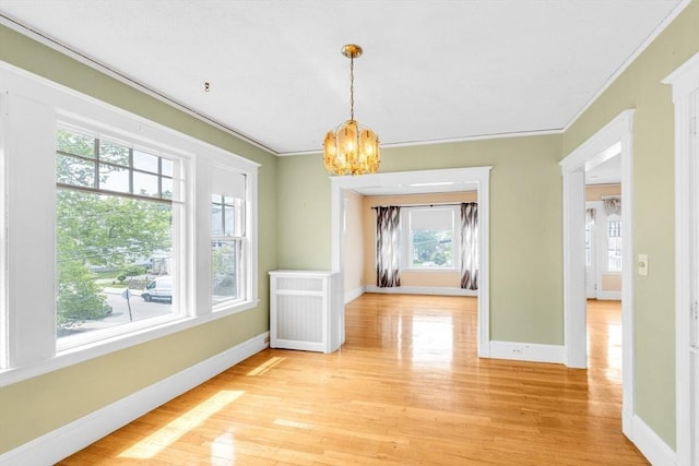 17 Matchett St, Boston, MA 02135 - unfurnished dining area with a chandelier, crown molding, light wood finished floors, and baseboards