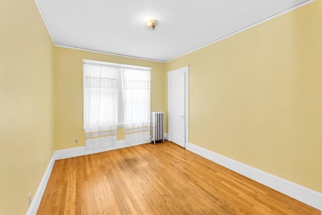 17 Matchett St, Boston, MA 02135 - spare room featuring radiator heating unit, light wood finished floors, baseboards, and crown molding