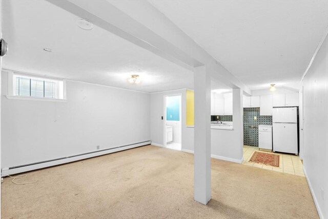 17 Matchett St, Boston, MA 02135 - below grade area featuring freestanding refrigerator, baseboard heating, light colored carpet, and baseboards