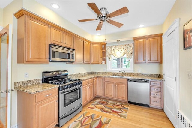17 Matchett St, Boston, MA 02135 - kitchen featuring stainless steel appliances, a sink, light wood-style flooring, a ceiling fan, and open shelves