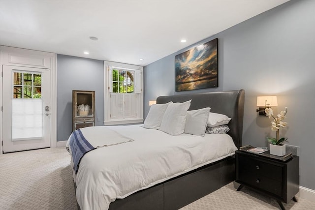 bedroom with light carpet, access to exterior, baseboards, multiple windows, and recessed lighting