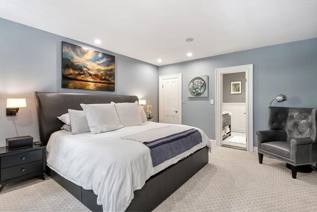 bedroom with carpet floors, recessed lighting, baseboards, and ensuite bath