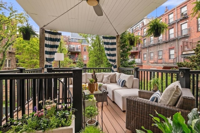 wooden terrace featuring an outdoor living space and ceiling fan