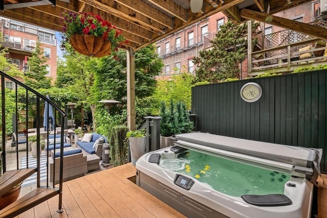 wooden deck featuring a hot tub