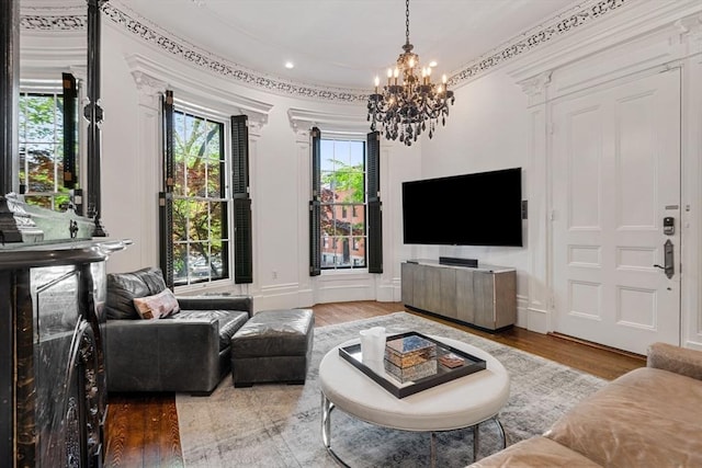 living area with a chandelier and wood finished floors