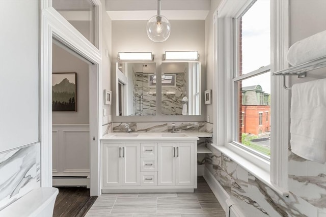 bathroom with hardwood / wood-style floors, vanity, and baseboard heating