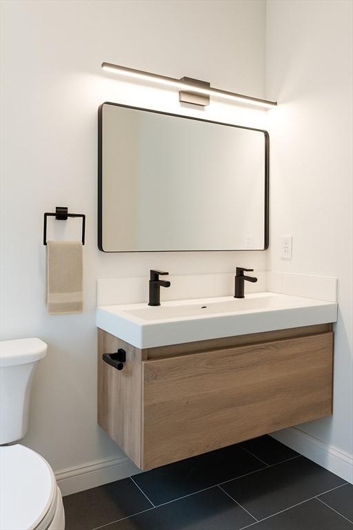 59 Dartmouth St Unit B, Somerville, MA 02145 - bathroom featuring toilet, vanity, baseboards, and tile patterned flooring