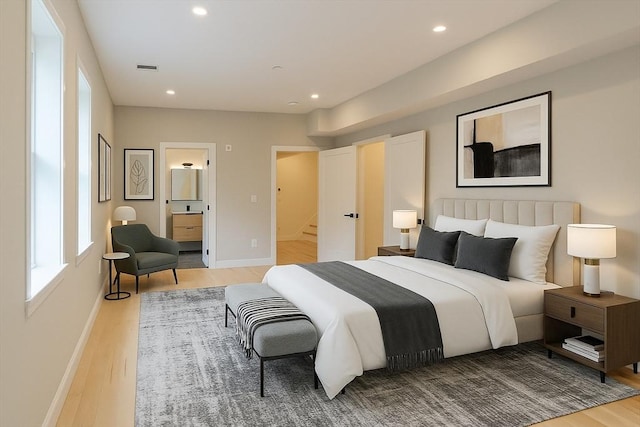 59 Dartmouth St Unit B, Somerville, MA 02145 - bedroom featuring wood finished floors, recessed lighting, baseboards, and ensuite bath
