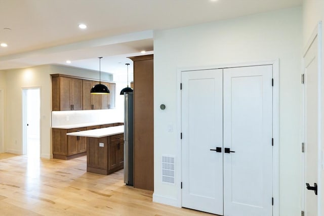 59 Dartmouth St Unit B, Somerville, MA 02145 - kitchen with recessed lighting, a kitchen island, light wood-style floors, light countertops, and hanging light fixtures