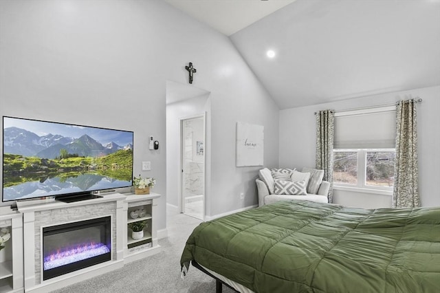 carpeted bedroom featuring vaulted ceiling, a fireplace, baseboards, and connected bathroom