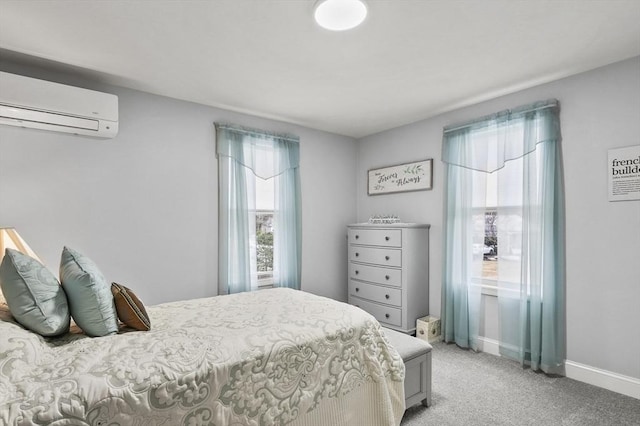 bedroom with a wall unit AC, light colored carpet, and baseboards