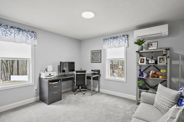 office space with a wall unit AC, baseboards, and light carpet