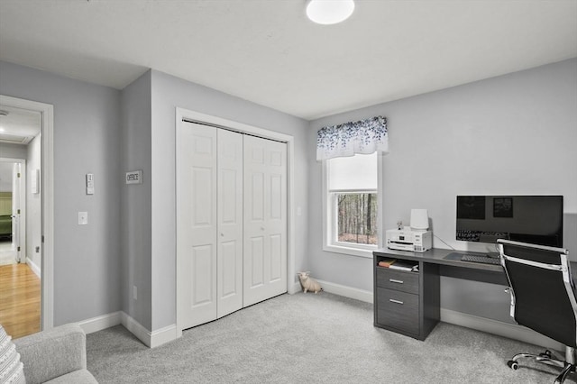 office space featuring light colored carpet and baseboards