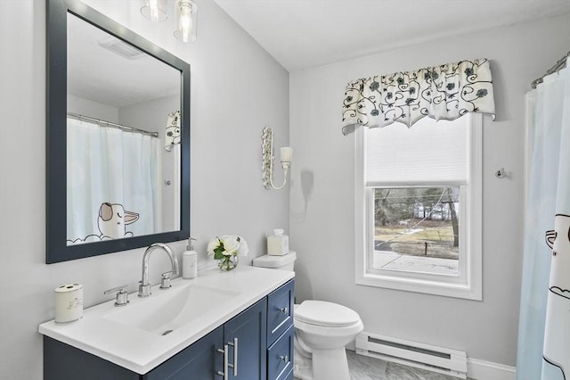 bathroom featuring toilet, vanity, a baseboard heating unit, and baseboards