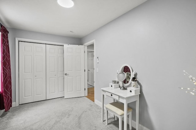 bedroom featuring a closet, baseboards, and carpet floors