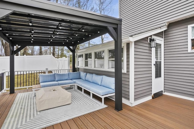 wooden terrace with an outdoor living space and fence