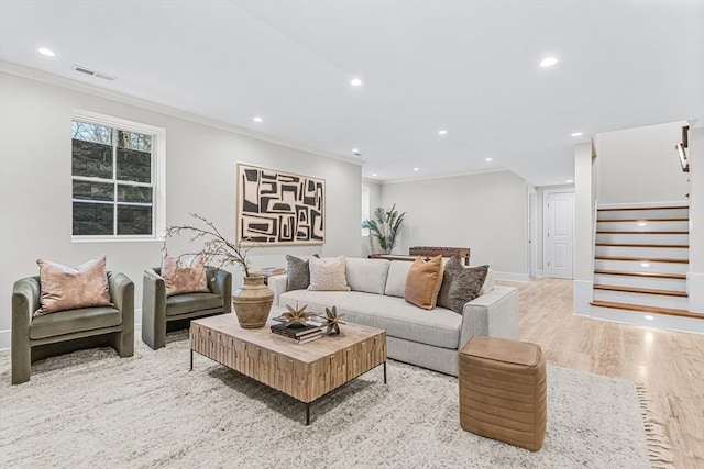 living area featuring recessed lighting, stairway, and ornamental molding