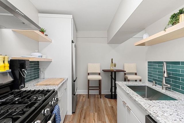 1992 Commonwealth Ave Unit B, Boston, MA 02135 - kitchen featuring open shelves, a sink, appliances with stainless steel finishes, and wall chimney exhaust hood