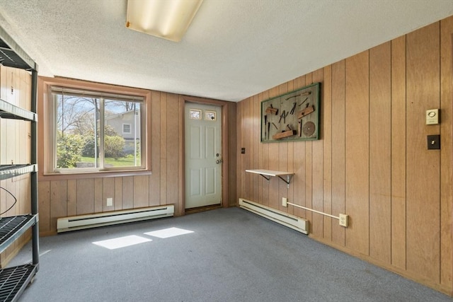 entrance foyer with a textured ceiling, carpet, and baseboard heating
