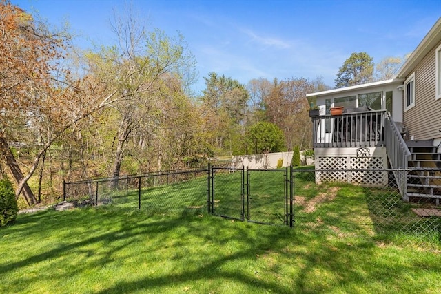 view of yard featuring stairway, a deck, fence, and a gate