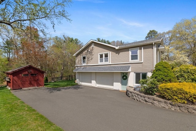 view of front of property with fence, an attached garage, driveway, and stucco siding