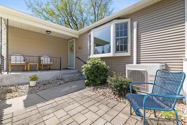 view of exterior entry featuring ac unit