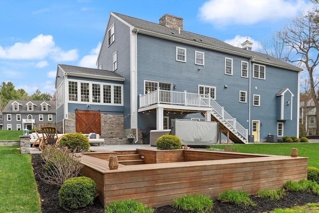 65 Stonegate Dr, East Bridgewater, MA 02333 - rear view of property with a chimney, stairway, stone siding, and a deck
