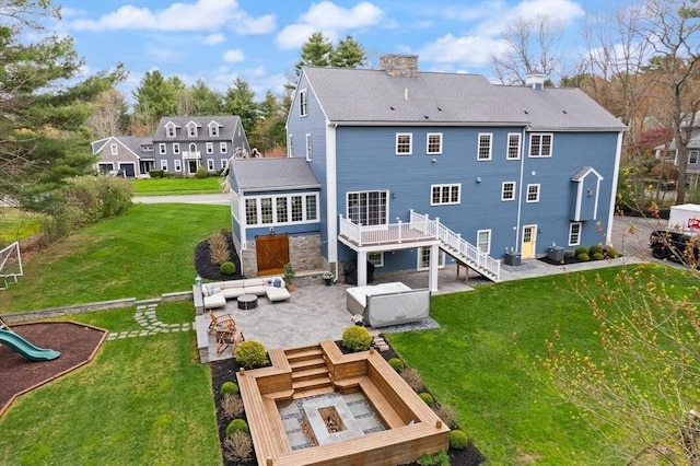 65 Stonegate Dr, East Bridgewater, MA 02333 - back of property featuring a chimney, a wooden deck, stairway, a covered hot tub, and a patio