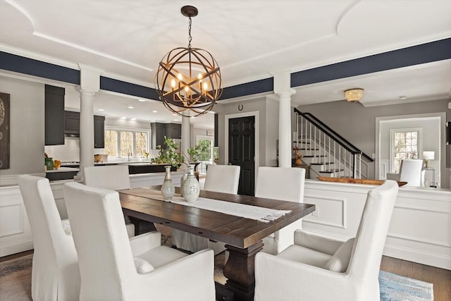 65 Stonegate Dr, East Bridgewater, MA 02333 - dining space with dark wood-style floors, ornate columns, a notable chandelier, and ornamental molding