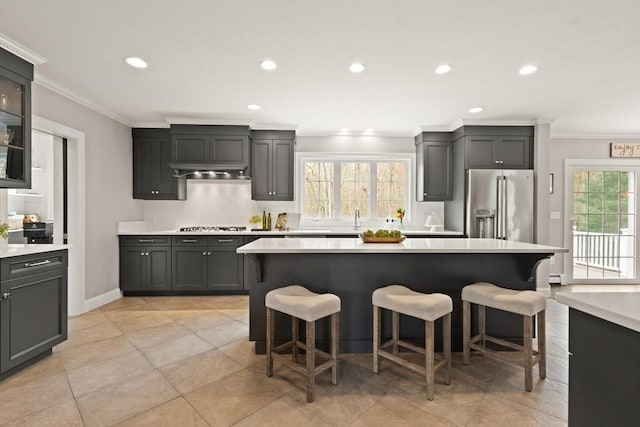 65 Stonegate Dr, East Bridgewater, MA 02333 - kitchen with light countertops, a kitchen breakfast bar, appliances with stainless steel finishes, and ornamental molding