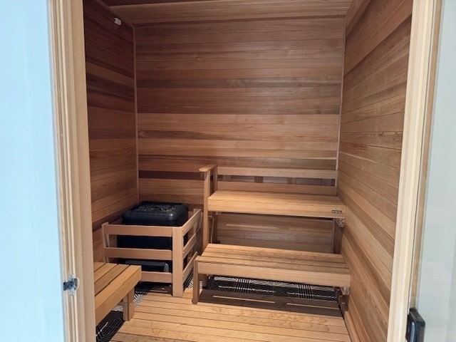 view of sauna / steam room featuring wood walls and hardwood / wood-style floors