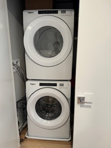 washroom featuring stacked washer / drying machine