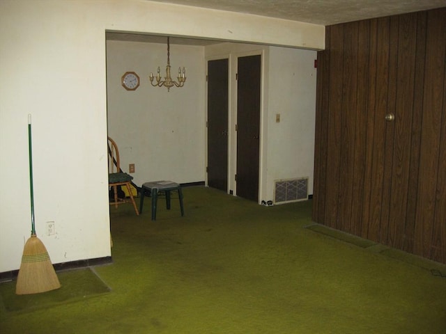22 Kingswood Dr Unit 6F, Abington, MA 02351 - spare room featuring carpet, wood walls, and a chandelier