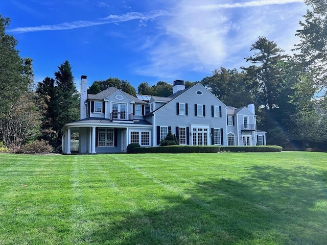 colonial home with a front lawn