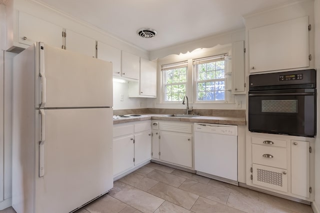 kitchen with white appliances, sink, and white cabinets