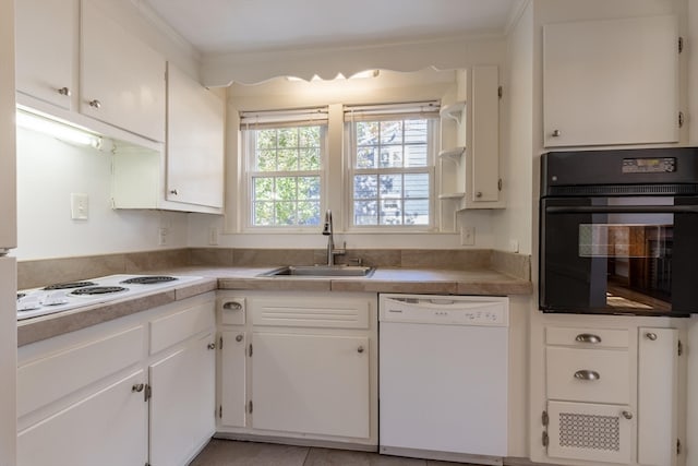 kitchen featuring white appliances, ornamental molding, white cabinets, and sink