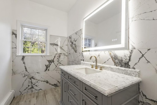 full bath with tile walls, vanity, and visible vents