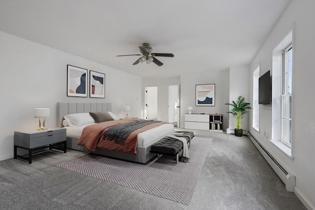 carpeted bedroom with baseboards, multiple windows, and baseboard heating
