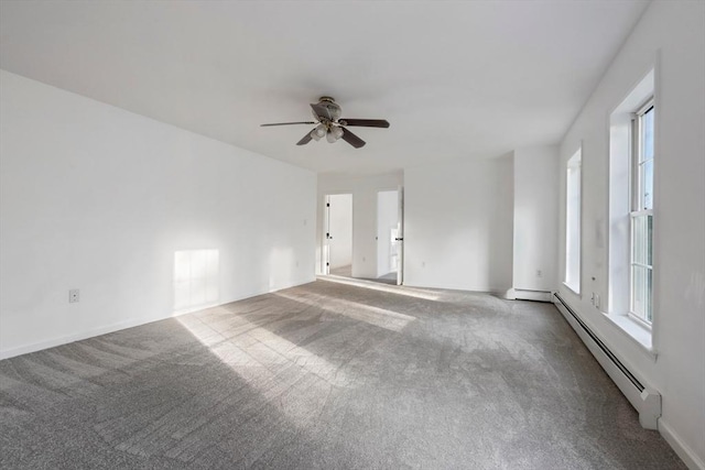 carpeted empty room with a ceiling fan, baseboards, and baseboard heating