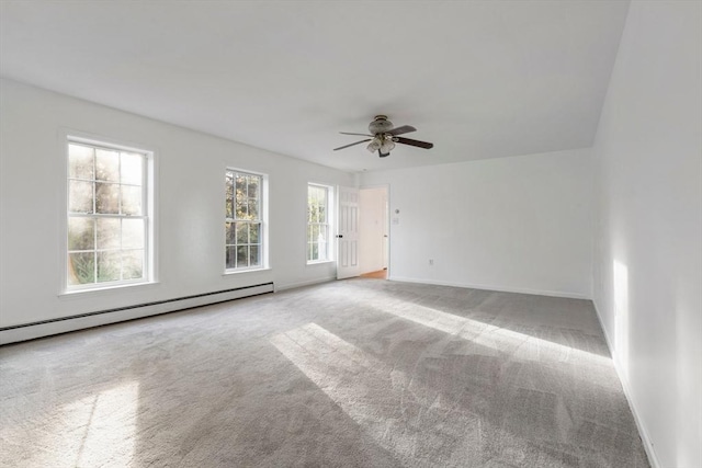 carpeted empty room with ceiling fan, baseboards, and a baseboard heating unit