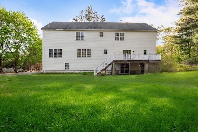 back of house with a lawn, stairway, and a wooden deck