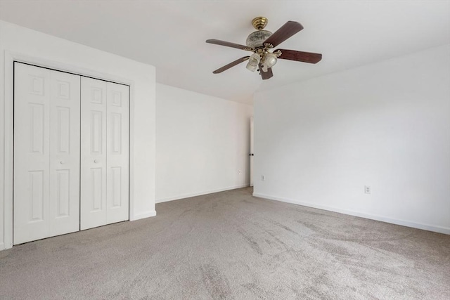 unfurnished bedroom featuring carpet, a closet, and baseboards