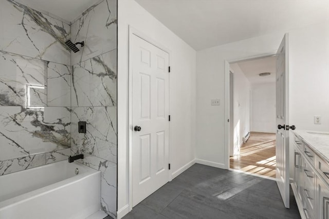bathroom featuring a baseboard radiator,  shower combination, and vanity
