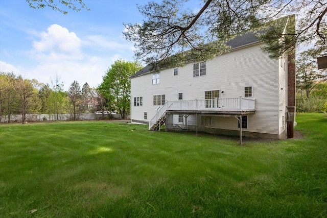 back of house featuring a wooden deck, stairway, fence, and a lawn