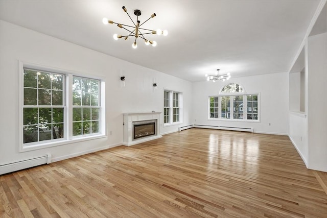unfurnished living room featuring a glass covered fireplace, a baseboard radiator, a chandelier, and light wood-style flooring