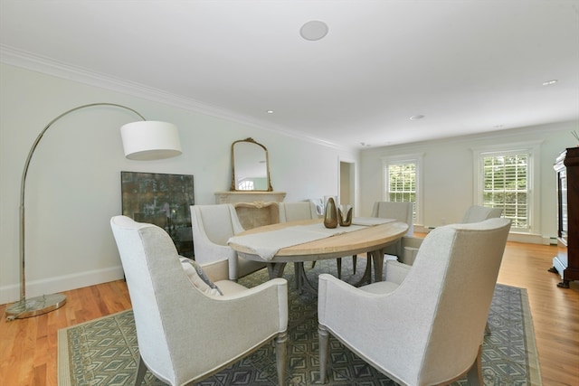 dining space with dark wood-type flooring and ornamental molding