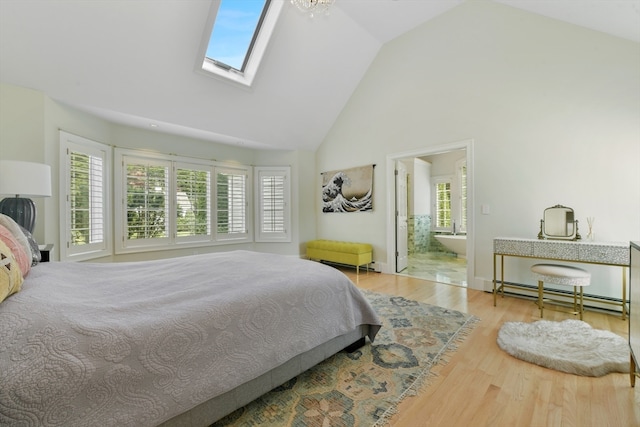 bedroom featuring ensuite bathroom, high vaulted ceiling, a skylight, baseboard heating, and light wood-type flooring