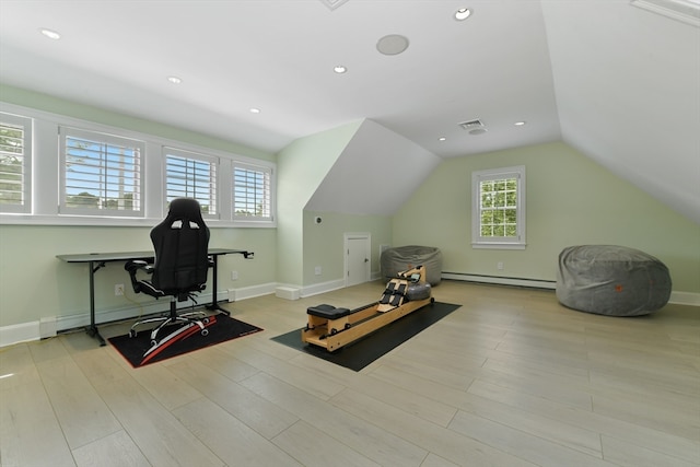 workout area with light hardwood / wood-style flooring, a baseboard radiator, and vaulted ceiling